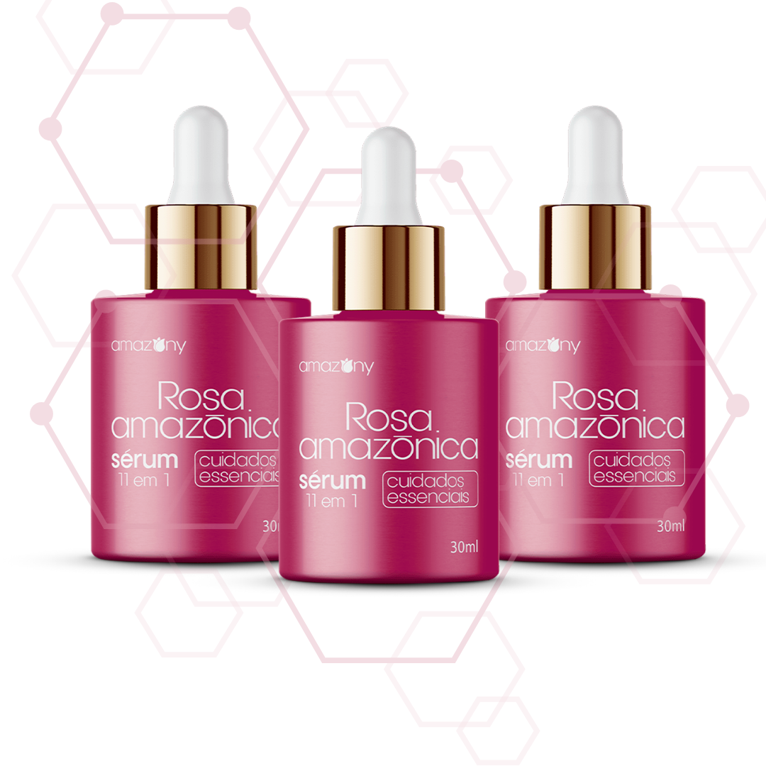 Três frascos do Sérum Rosa Amazônica, com embalagem rosa escura, conta-gotas dourado e fundo com padrões hexagonais.